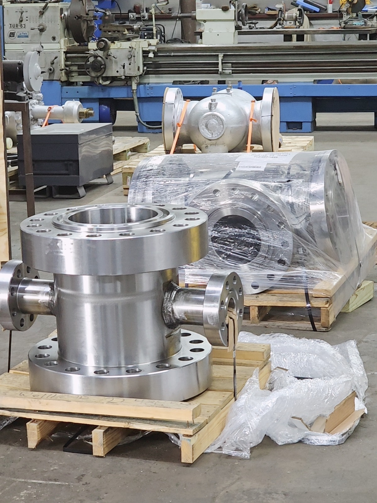 EPI Wellhead Assembly silver flanged components in workshop